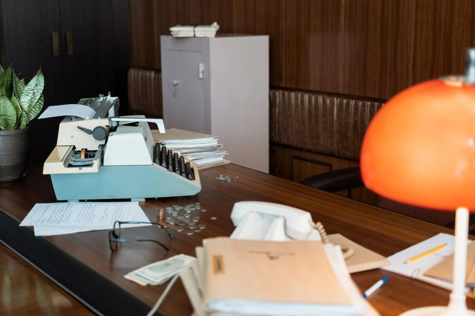 A vintage typewriter sits on a wooden desk in a nostalgic office.
