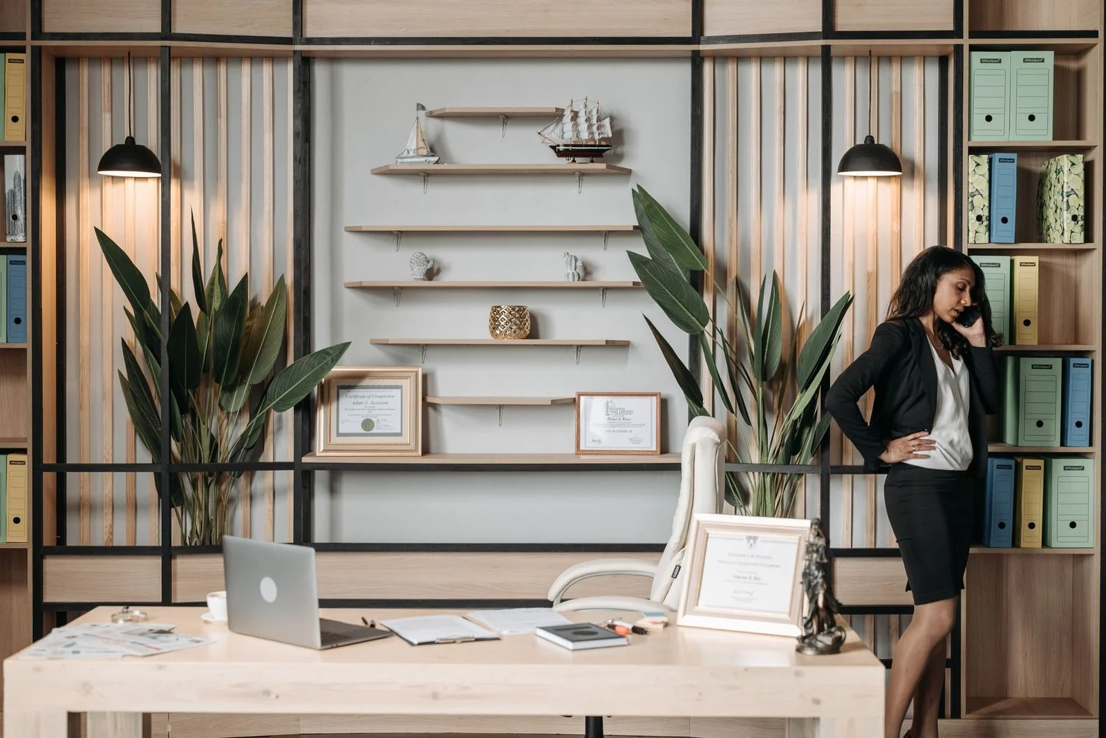 Businesswoman on a phone in a stylish, modern office.