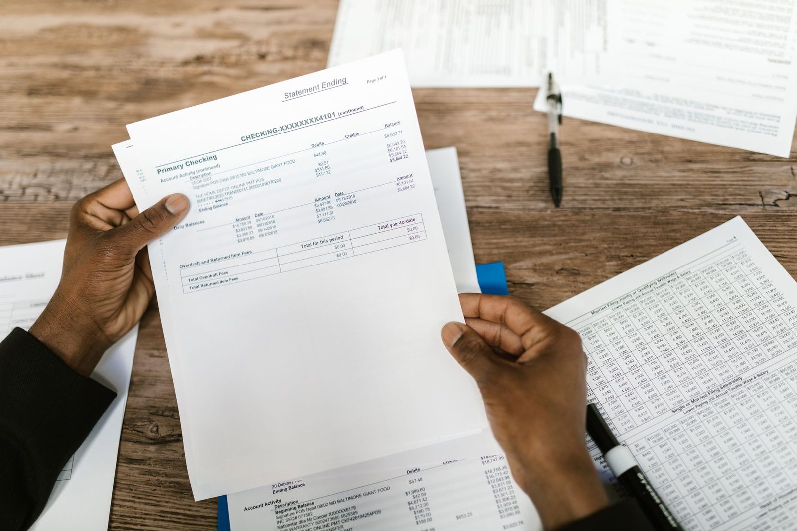 Financial documents being reviewed for tax preparation and analysis.