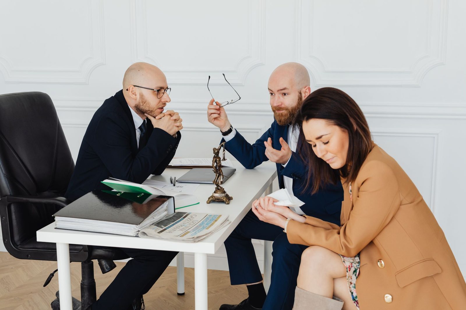 Lawyers mediating a dispute between clients in a conference room.