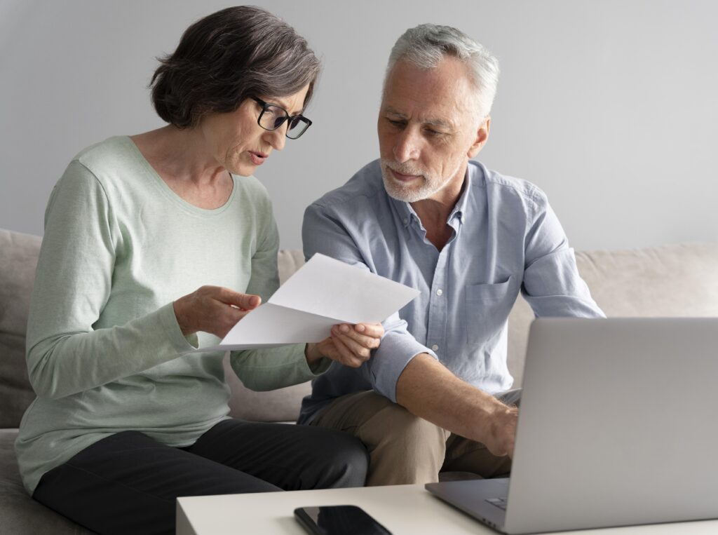 Elderly Florida couple reviewing divorce paperwork, discussing estate planning and probate concerns during late-life separation.