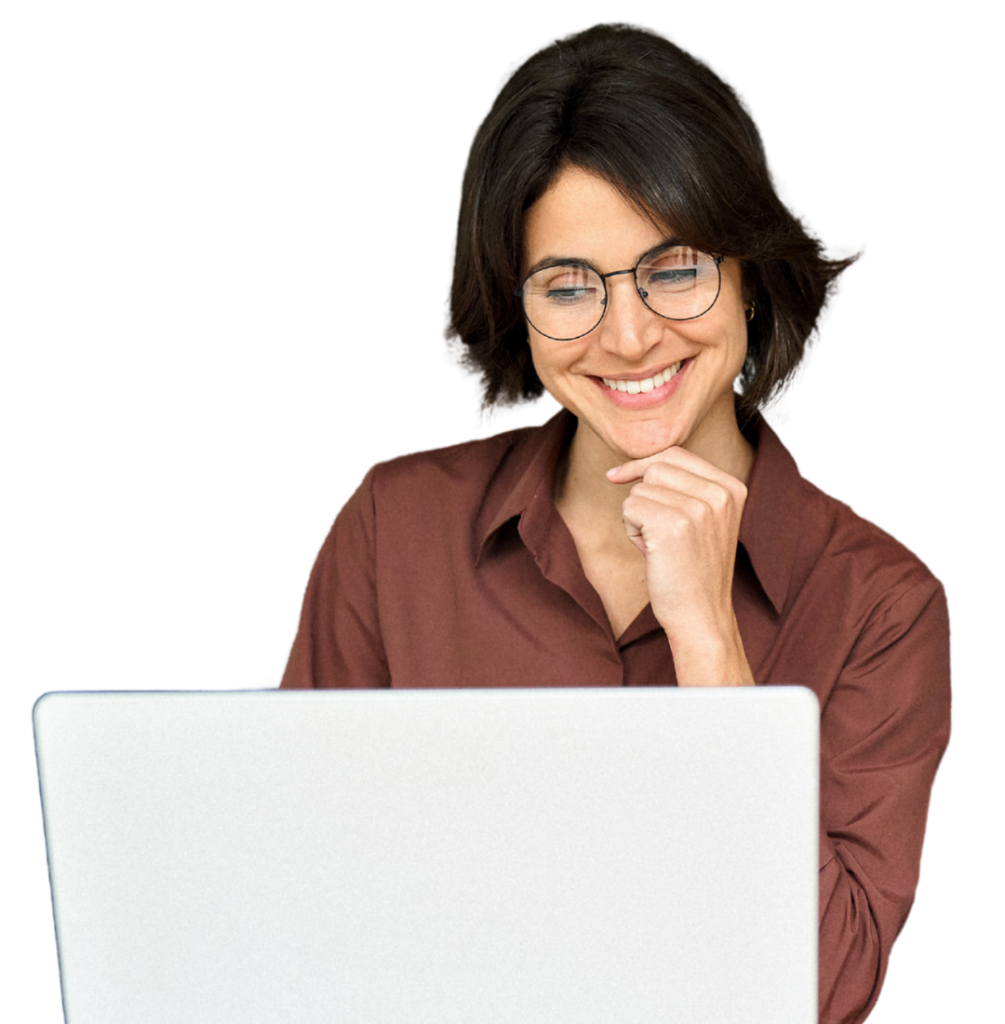 Woman with short dark hair and round glasses smiling while using a laptop.