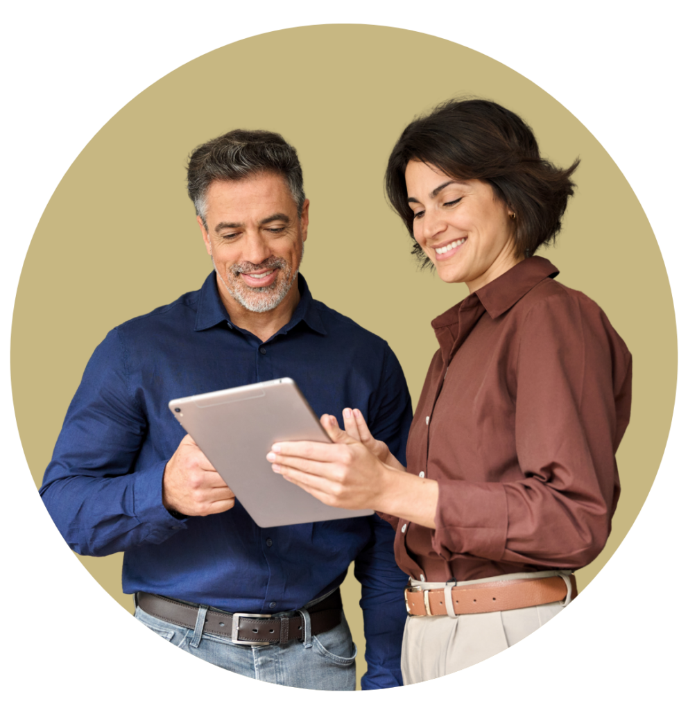 Two colleagues review content on a tablet together, smiling as they look at the screen in a beige circular background.