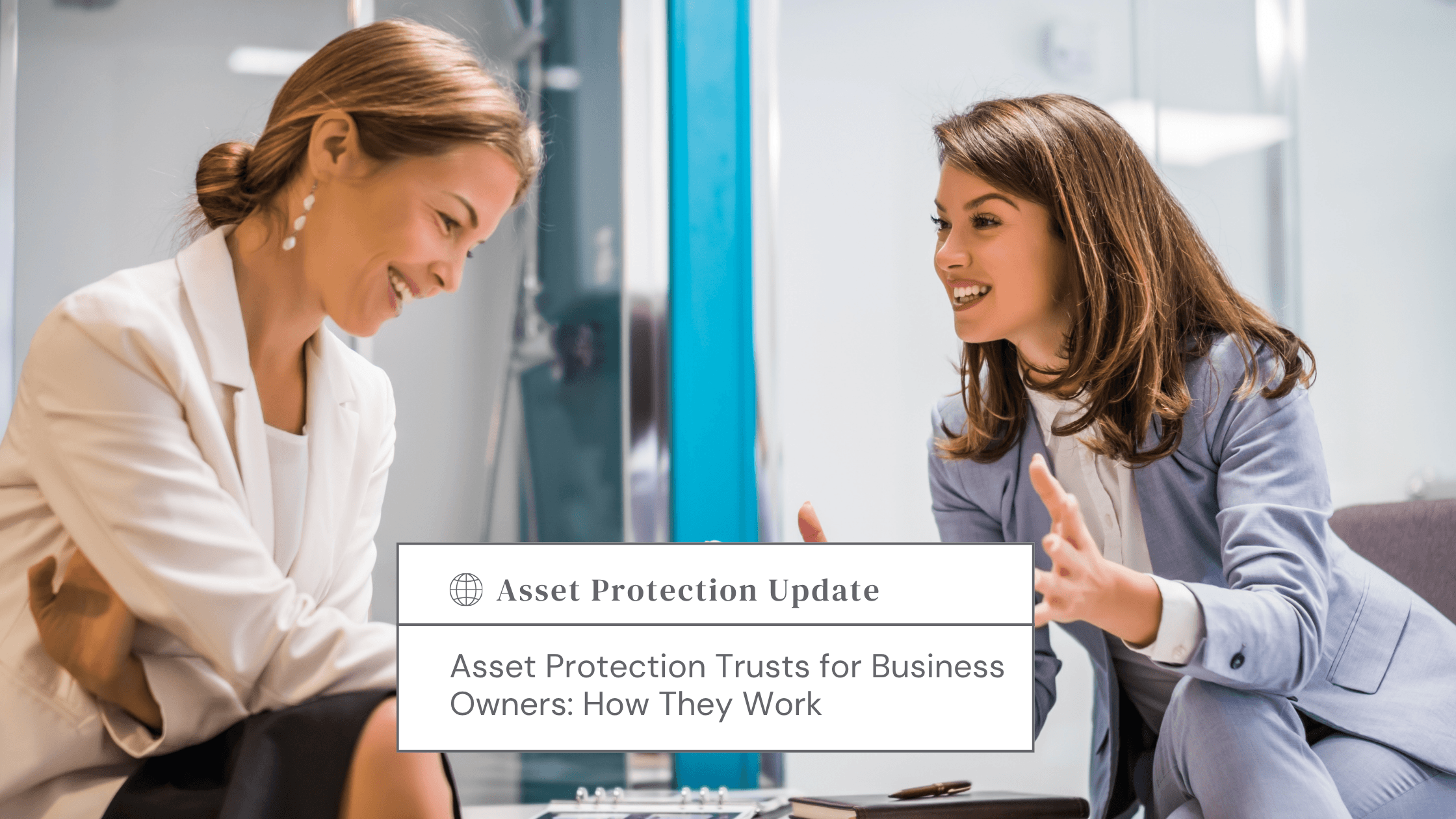 Blog-Article Covers 11 - Estate Planning & Probate Attorneys Two women in business attire smile and discuss a document titled Asset Protection Update on a desk in a bright office.
